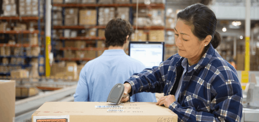 woman scanning a box in a warehouse
