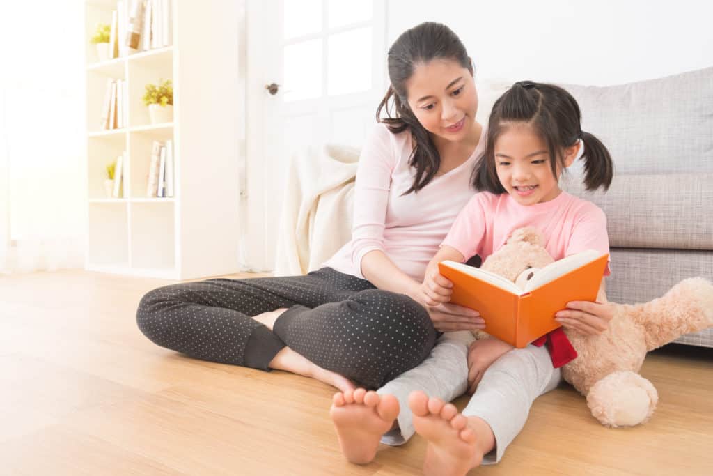 Mom and daughter reading on floor